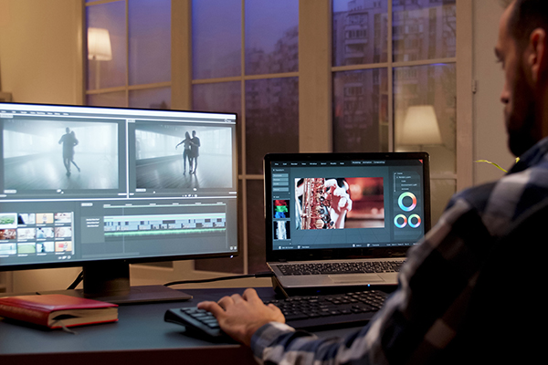 Back view of content creator working in home office